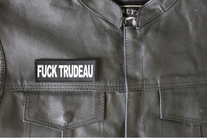 Fuck Trudeau Patch - 4x1.5 inch - Embroidered Iron on Patch shown on leather vest