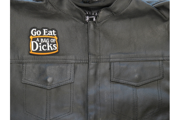 Go Eat a Bag of Dicks Patch shown on leather vest