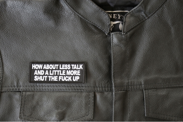 How about Less Talk and a Little More Shut the Fuck Up Patch - 4x1.5 inch - Embroidered Iron on Patch shown on leather vest