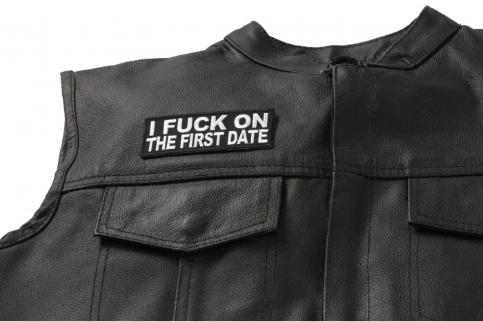 I Fuck On The First Date Patch - 4x1.5 inch. Embroidered Iron on Patch shown on leather vest