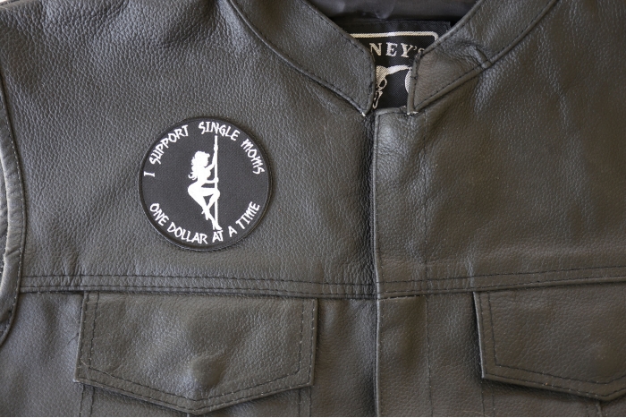 I Support Single Moms One Dollar at a Time Patch - 3x3 inch. Embroidered Iron on Patch shown on leather vest