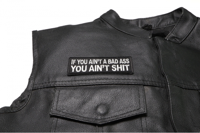 If You Ain't A Bad Ass You Ain't Shit Patch - 4x1.5 inch. Embroidered Iron on Patch shown on leather vest