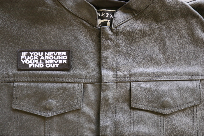 If you never Fuck around you'll Never Find Out Patch, Biker Sayings shown on leather vest
