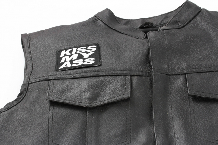 Kiss My Ass Patch - 3x2.25 inch. Embroidered Iron on Patch shown on leather vest