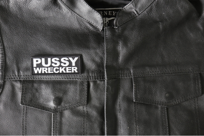 Pussy Wrecker Patch - 4x1.5 inch - Embroidered Iron on Patch shown on leather vest