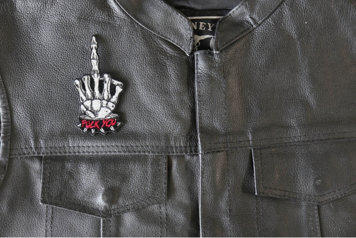 Skeleton Fuck You Middle Finger Patch - 2x4 inch - Embroidered Iron on Patch shown on leather vest