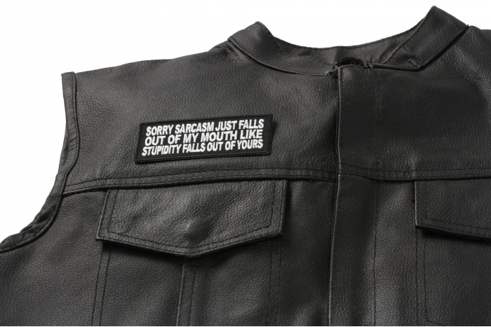 Sorry Sarcasm Just Falls Out Of My Mouth Patch - 4x1.5 inch. Embroidered Iron on Patch shown on leather vest