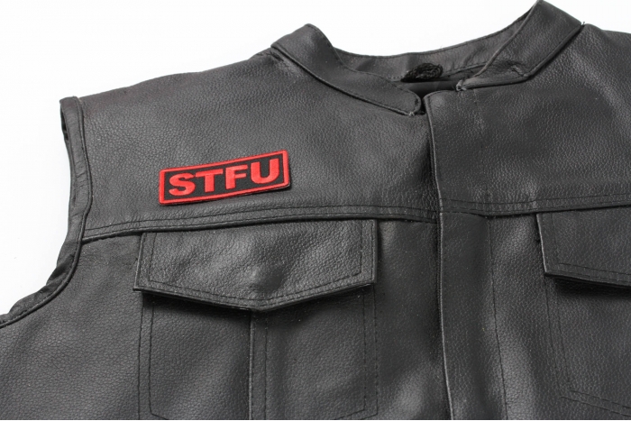 Stfu Patch - 3x1.25 inch. Embroidered Iron on Patch shown on leather vest