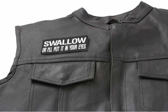 Swallow or I'll Put It In Your Eyes Patch - 4x1.75 inch. Embroidered Iron on Patch shown on leather vest