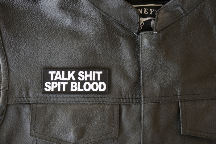 Talk Shit Spit Blood Patch - 4x1.5 inch - Embroidered Iron on Patch shown on leather vest