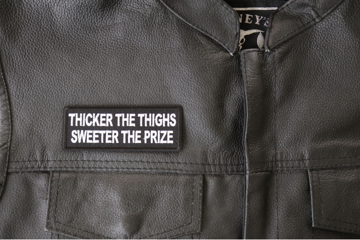 Thicker the Thighs Sweeter the Prize Patch - 4x1.5 inch - Embroidered Iron on Patch shown on leather vest