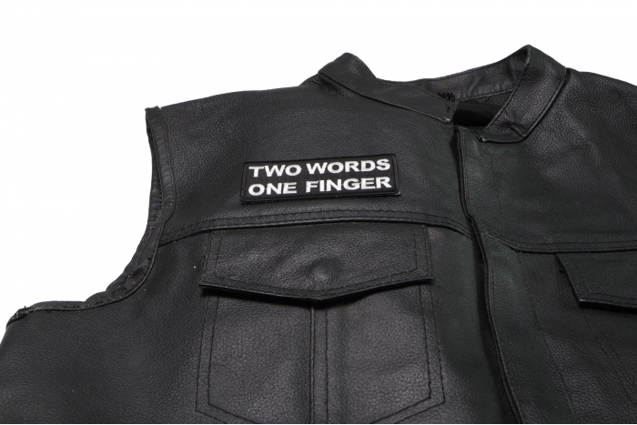 Two Words One Finger Patch - 4x1.5 inch. Embroidered Iron on Patch shown on leather vest