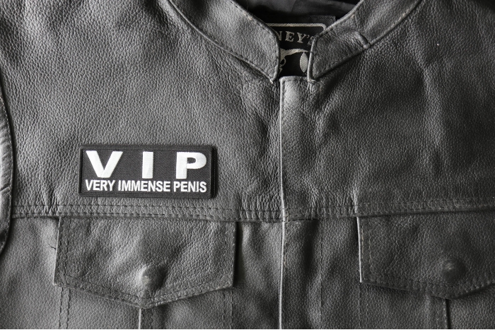 VIP Very Immense Penis Patch - 4x1.5 inch - Embroidered Iron on Patch shown on leather vest