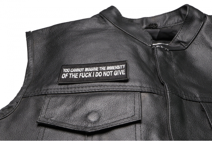 You Cannot Imagine The Immensity of The Fuck I Do Not Give Patch - 4x1.5 inch. Embroidered Iron on Patch shown on leather vest