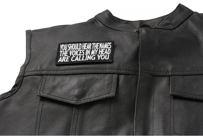 You Should Hear The Names The Voices In My Head Are Calling You Patch - 4x2 inch. Embroidered Iron on Patch shown on leather vest
