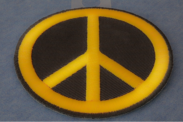 Peace Sign Iron on Patch Yellow On Black diagonal view
