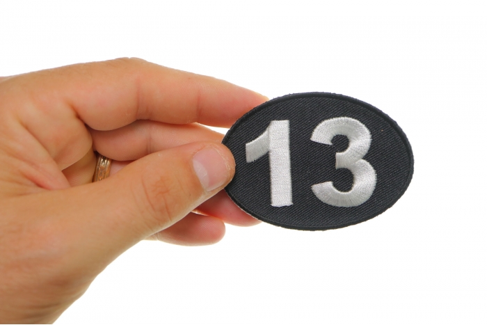 Lucky 13 Iron on Novelty Patch shown on hand for size comparison