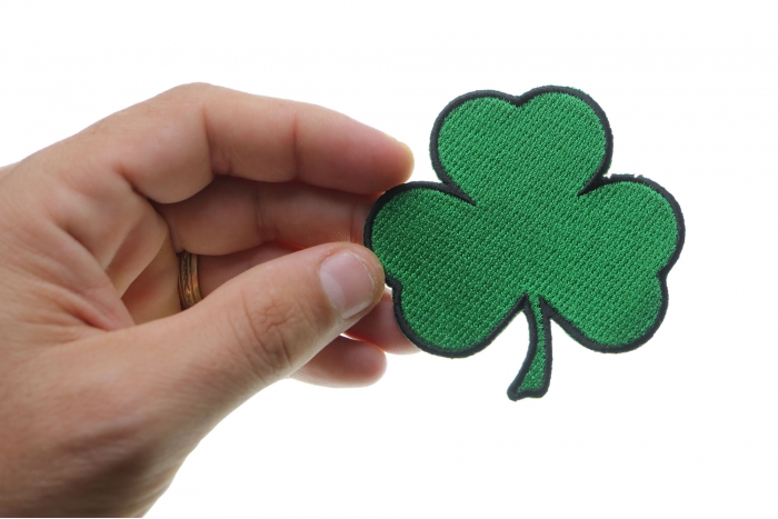 3 Leaf Clover Shamrock Novelty Iron on Patch shown on hand for size comparison