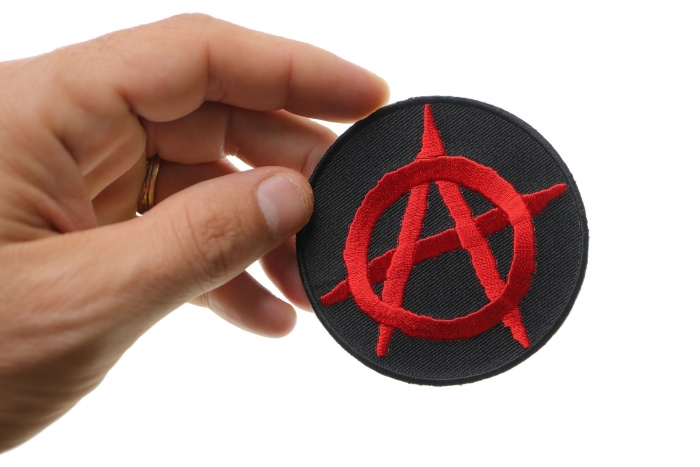 Anarchy Red Round Novelty Iron on Patch shown on hand for size comparison