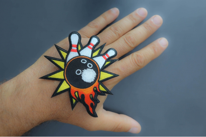 Bowling Patch shown on hand for size comparison