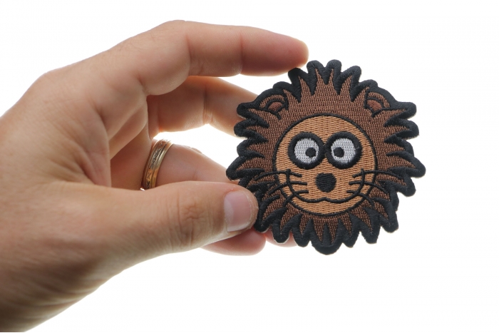 Brown Lion Head Patch shown on hand for size comparison