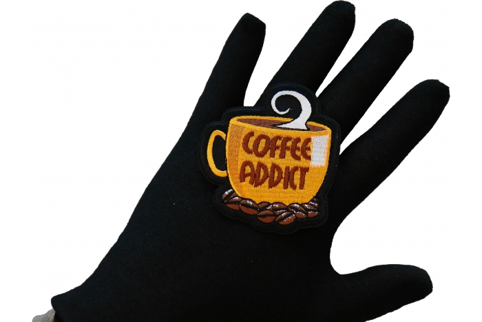 Coffee Addict Patch shown on hand for size comparison