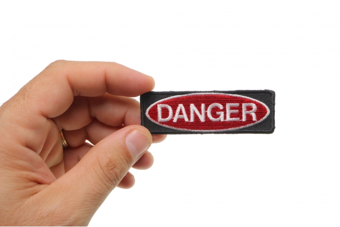 Danger Iron on Novelty Patch shown on hand for size comparison