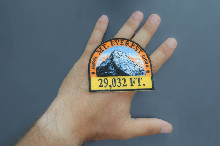 Everest Patch shown on hand for size comparison