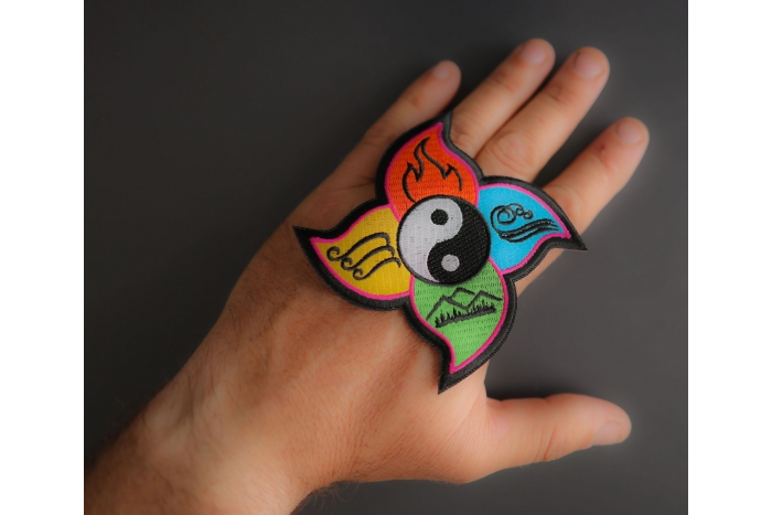 Four Elements Patch shown on hand for size comparison