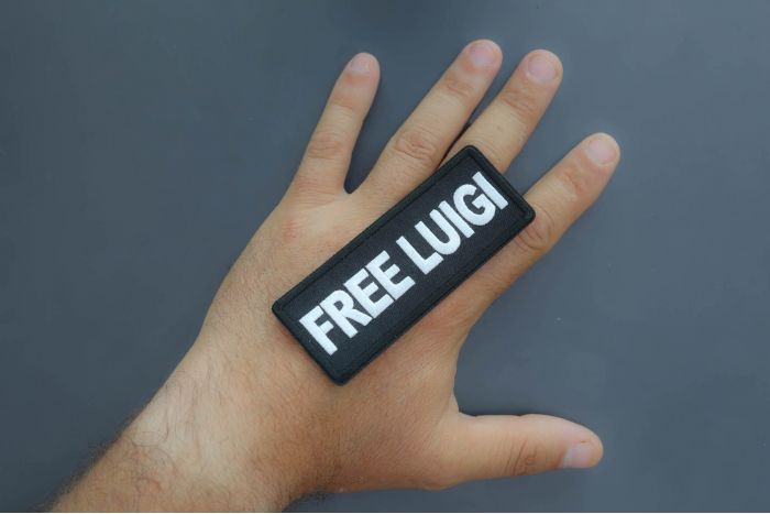 Free Luigi Patch shown on hand for size comparison