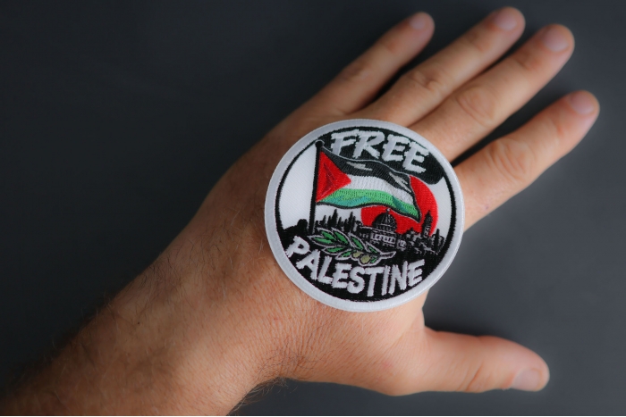 Free Palestine Patch shown on hand for size comparison