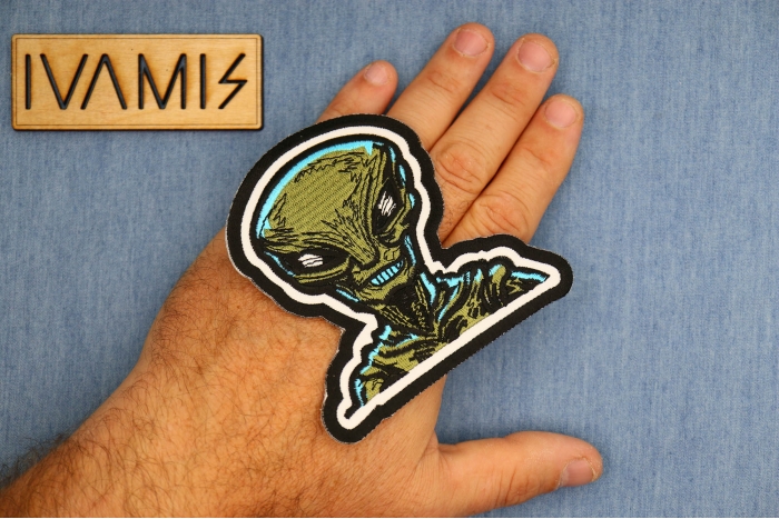 Green Alien Patch shown on hand for size comparison
