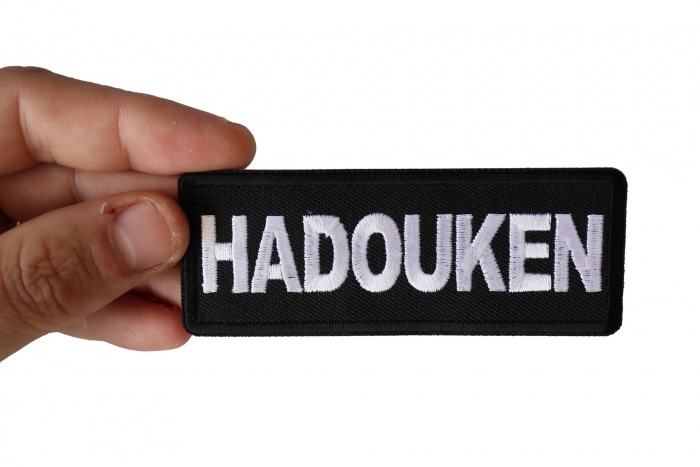 Hadouken Funny Iron on Patch shown on hand for size comparison
