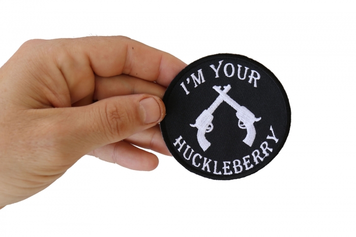I'm Your Huckleberry Black White Iron on Novelty Patch shown on hand for size comparison