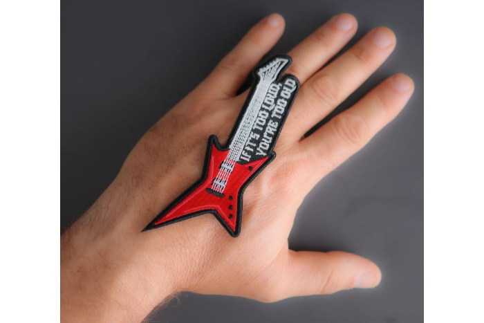 If it's too loud you're too old guitar patch shown on hand for size comparison