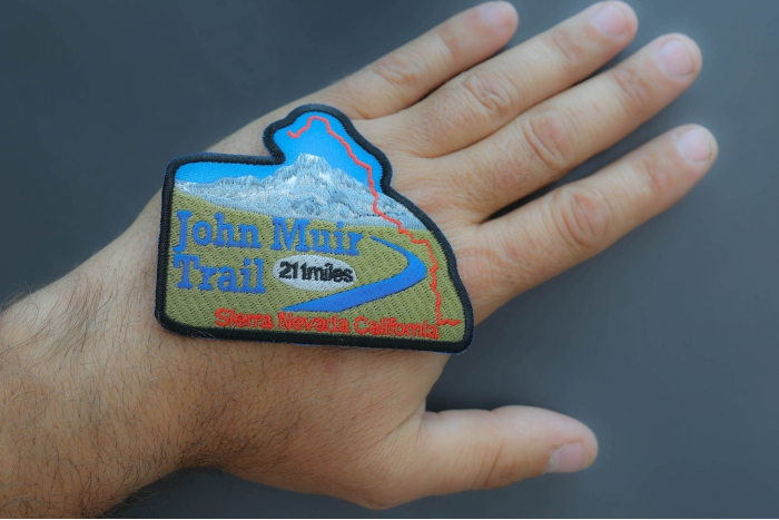 John Muir Trail Patch shown on hand for size comparison