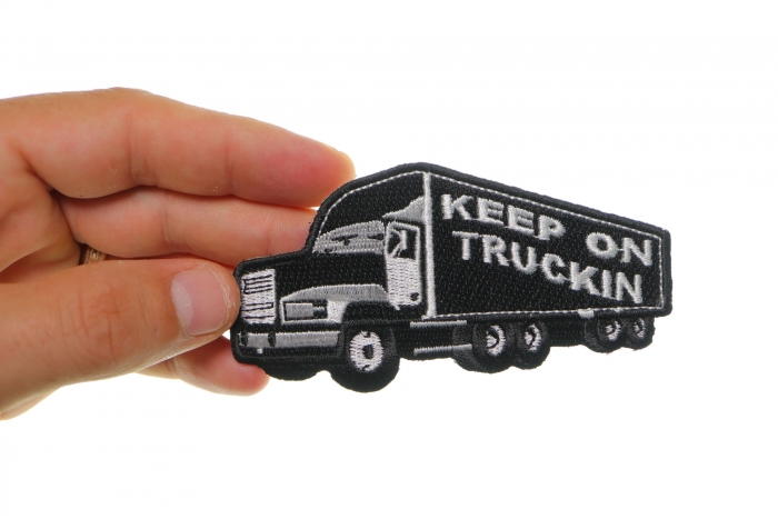 Keep On Trucking Iron on Novelty Patch shown on hand for size comparison