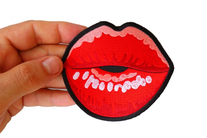 Kissing Lips Iron on Novelty Patch shown on hand for size comparison