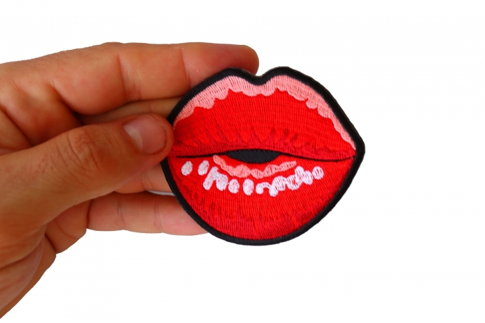 Kissing Lips Small Iron on Novelty Patch shown on hand for size comparison