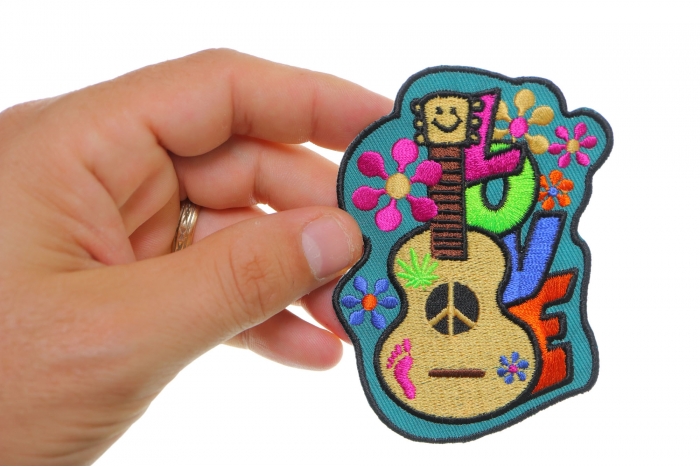 Love Guitar Cute Novelty Iron on Patch shown on hand for size comparison