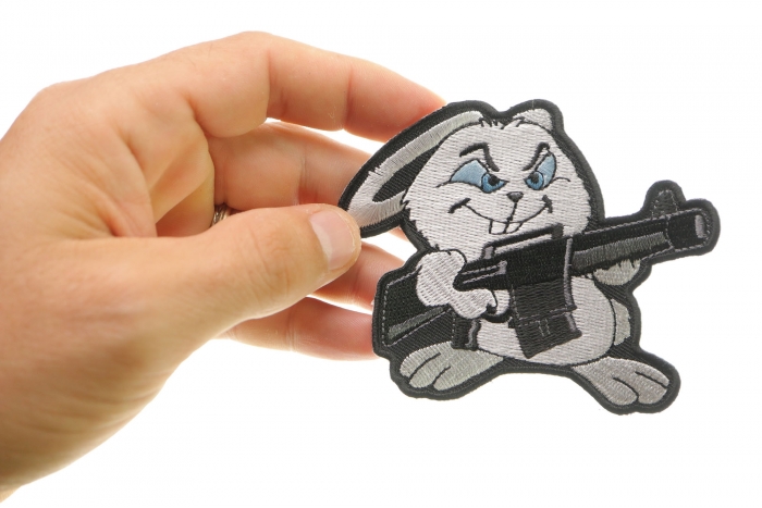 Machine Gun Bunny Rabbit Novelty Iron on Patch shown on hand for size comparison