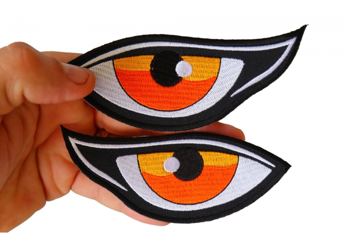 Medium Orange Eyes Iron on Patch shown on hand for size comparison