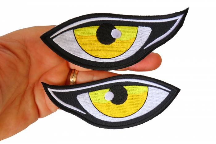 Medium Yellow Eyes Iron on Patch shown on hand for size comparison