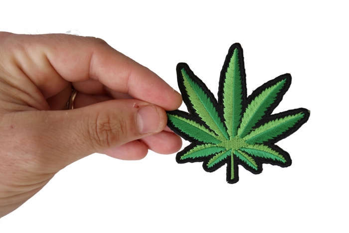 Pot Leaf Novelty Iron on Patch shown on hand for size comparison