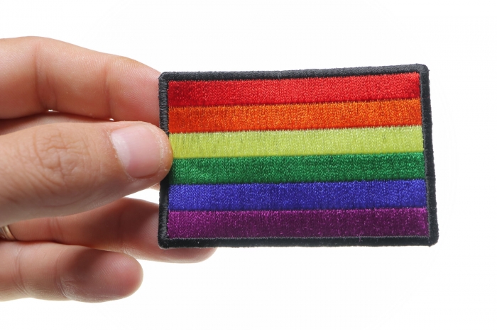 Rainbow Flag LGBTQ Iron on Novelty Patch shown on hand for size comparison