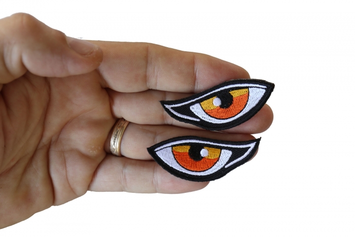 Orange Eyes Patches shown on hand for size comparison