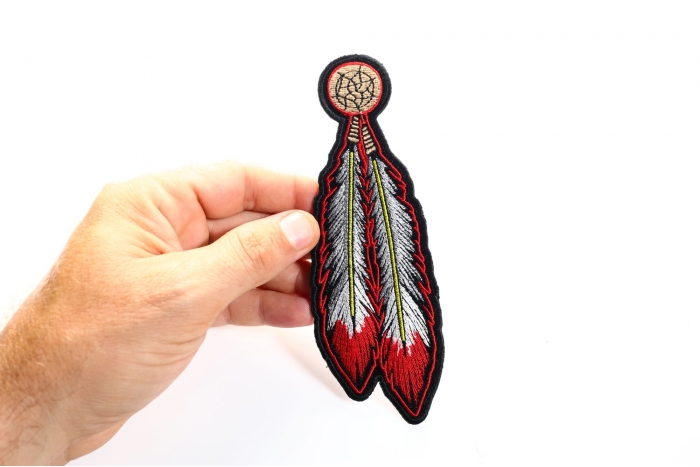 Feather Iron on Applique Patch for Jackets shown on hand for size comparison