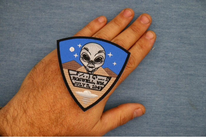 Roswell New Mexico Alien Patch shown on hand for size comparison