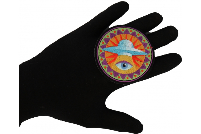 Spiritual Eye UFO Novelty Iron on Patch shown on hand for size comparison