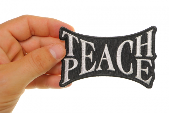 Teach Peace Novelty Iron on Patch shown on hand for size comparison